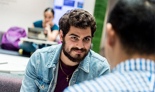 A student having a conversation with an older mentor