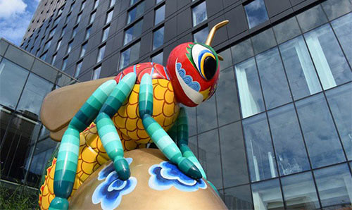 The front of the Hyatt Regency Hotel with the Beejing sculpture in the foreground